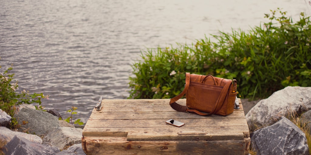 Bag and smartphone over a cliff