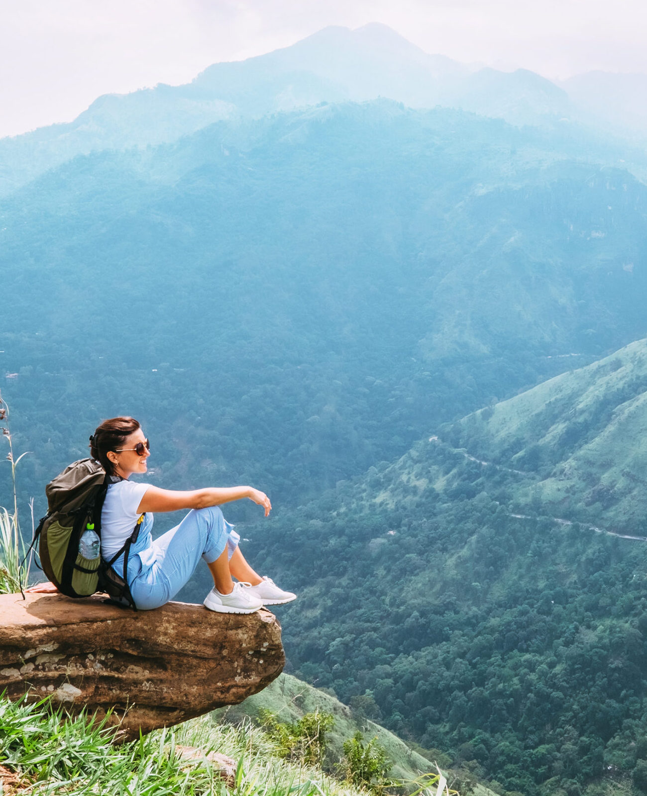 Woman sitting on a mountain top